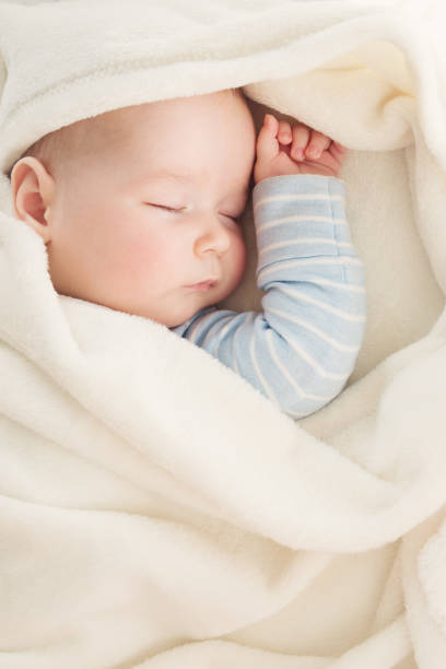istock Baby sleeping covered with soft white blanket 1042607058