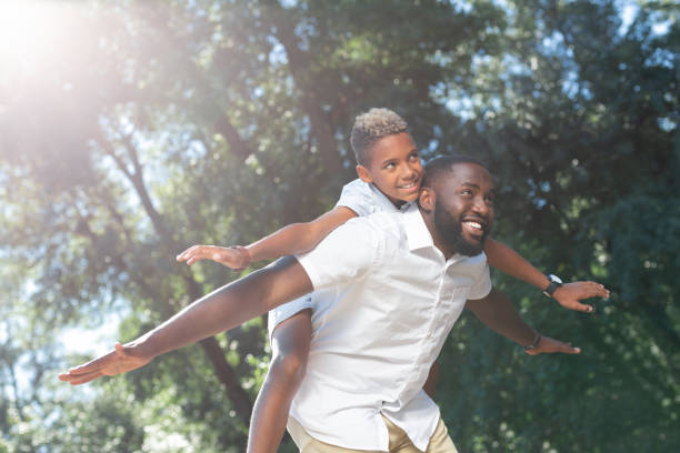 istock Nice joyful boy being carried by his father 1042610134