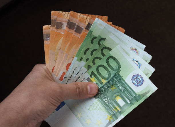 istock Hand with Euro notes, European Union 1042610236