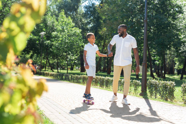 istock Joyful happy boy learning how to ride a skateboard 1042610280