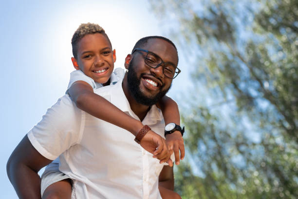istock Delighted nice father and son smiling to you 1042610534