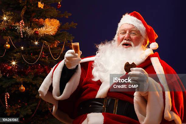 Jolly Father Christmas Enjoying A Sherry And Cookie Stock Photo - Download Image Now