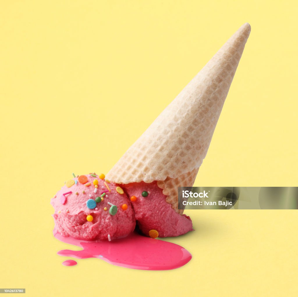 Upside Down Ice Cream Upside down ice cream cone squashed onto a yellow surface. Clipping path included. Ice Cream Stock Photo