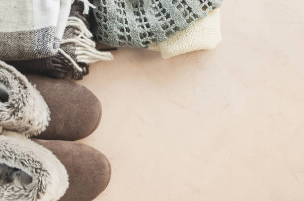 istock Warm home clothes. Woolen plaid and home slippers. 1042613910