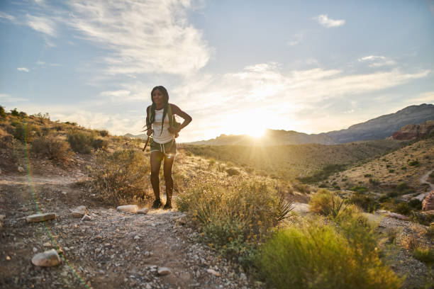 istock woman hiking at Red Rock Canyon during sunset with backpack 1042614034