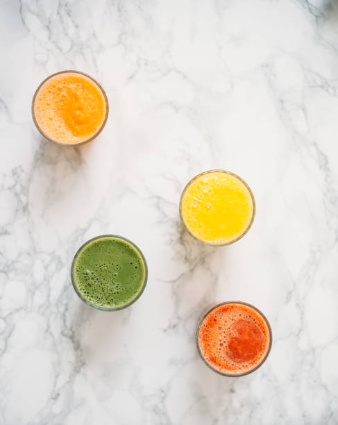 Colorful smoothies in glass with fresh tropical fruit and superfoods stock photo