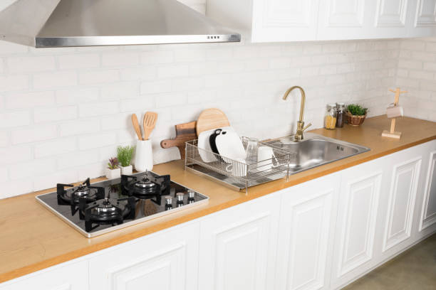 Kitchen utensils and dishware on wooden shelf. Kitchen interior background.Text space.