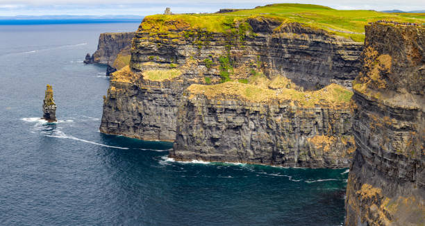 istock Caslte tower and rocks in Cliffs of Moher 1042618224