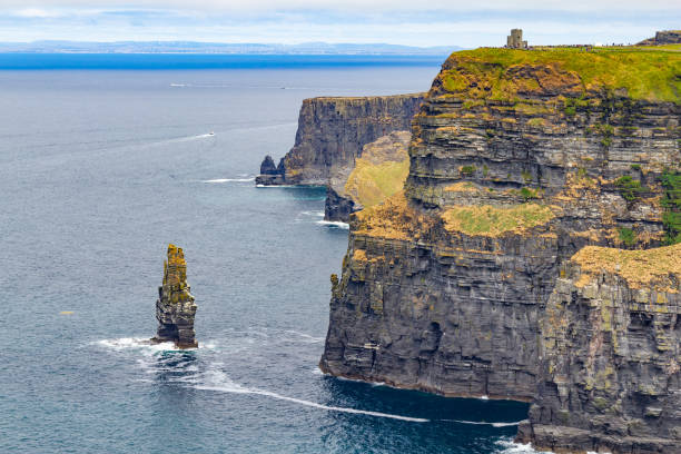 istock Caslte tower and rocks in Cliffs of Moher 1042618404