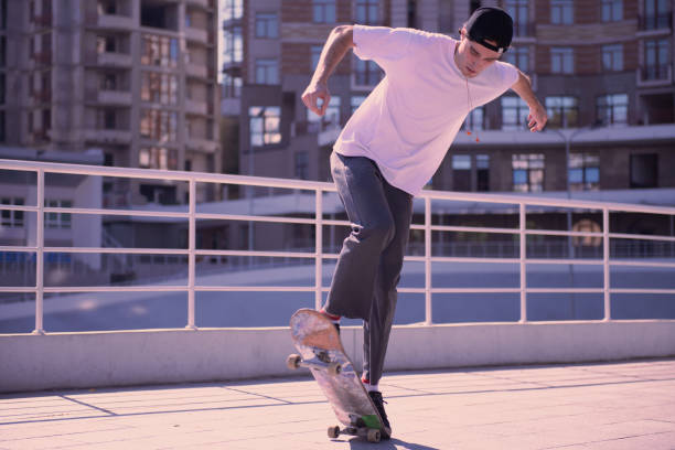 istock Concentrated stylish man jumping on his skateboard 1042631558