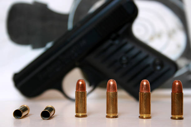istock Pistol and Target behind four bullets 104263485