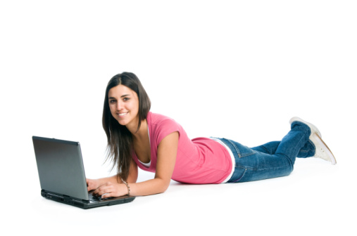 Happy smiling latin girl working adn surfing on laptop isolated on white background.