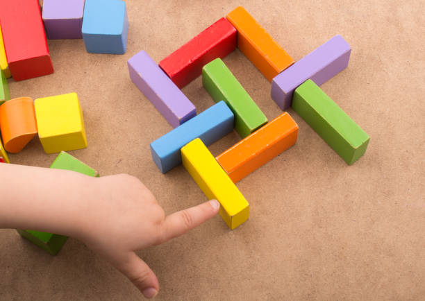 istock Toddler hand over Colorful building  blocks 1042647448