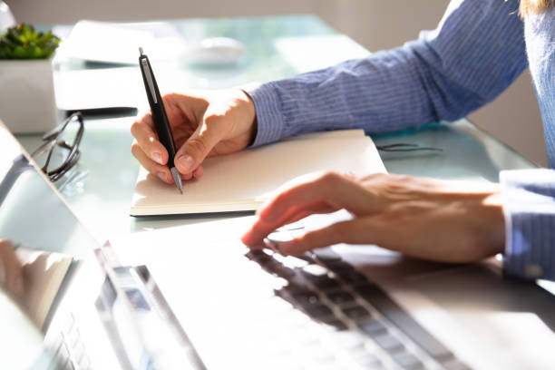 istock Businesswoman Writing Notes In Notebook 1042650214