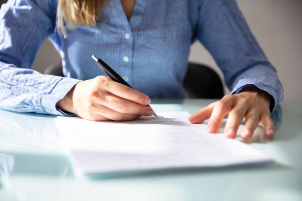 istock Businesswoman's Hand Signing Contract 1042650282