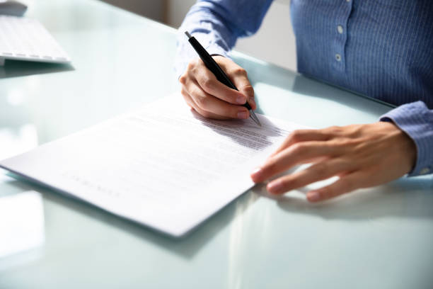 istock Businesswoman's Hand Signing Contract 1042650284