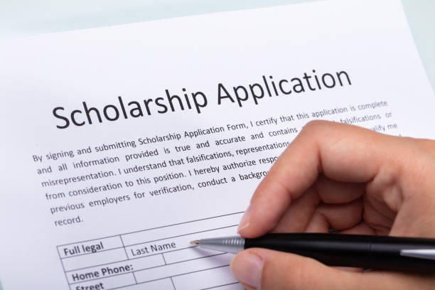 istock Person Filling Scholarship Form 1042650886