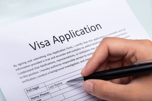istock Woman Filling Visa Application Form 1042650898