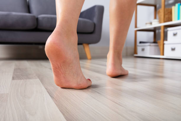 istock Woman's Foot Walking On Hardwood Floor 1042651064