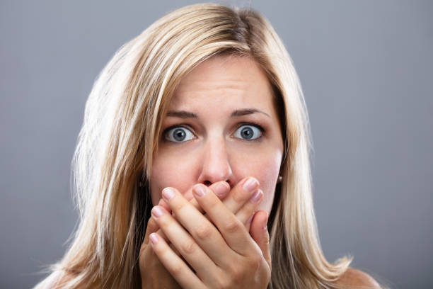 istock Shocked Woman With Hand On Mouth 1042651144