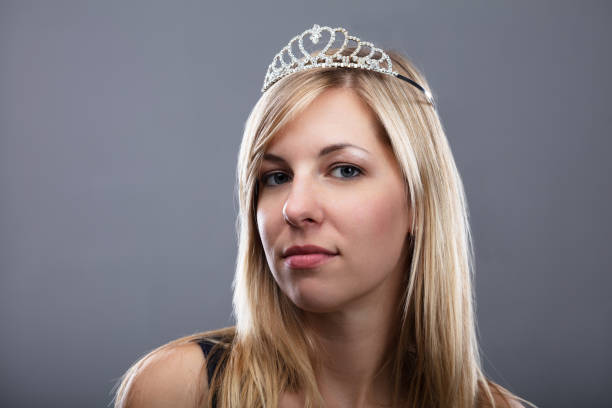 Young Woman With Tiara On Head Over Grey Background