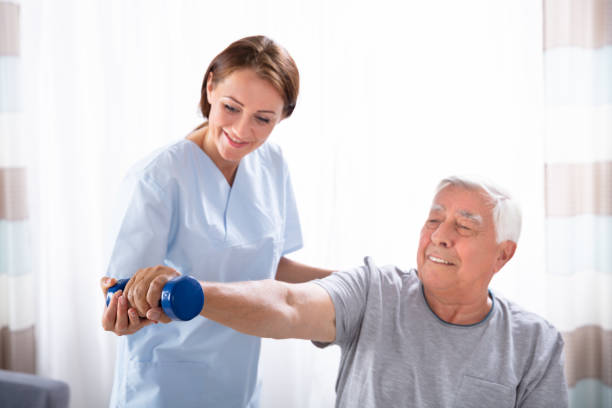istock Nurse Helping Senior Man With Dumbbell Exercise 1042652414