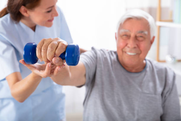 istock Nurse Helping Senior Man With Dumbbell Exercise 1042652416
