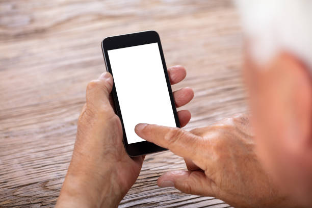 istock Senior Man Holding Mobile Phone 1042652438