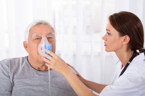 istock Doctor Holding Oxygen Mask Over Man's Face 1042653090