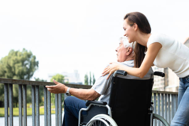 istock Woman With Her Disabled Father Near Railing 1042653150