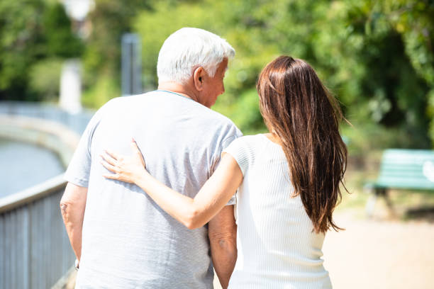istock Woman Assisting Her Father While Walking 1042653176