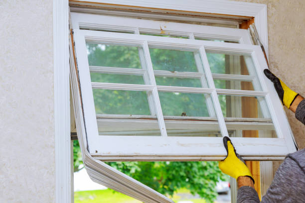 istock Hand of a worker replacing the old wooden window 1042653440