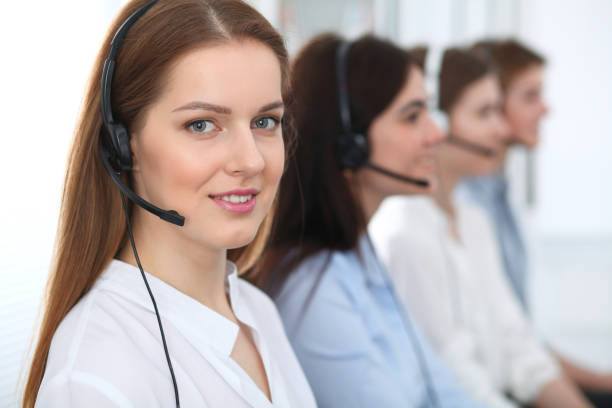 istock Call center. Beautiful cheerful smiling operator consulting clients with headset. Business concept of customer service. 1042656754