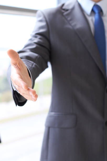 istock Unknown business man offering handshake while standing straight. Success cooperation and agreement concepts. 1042656796