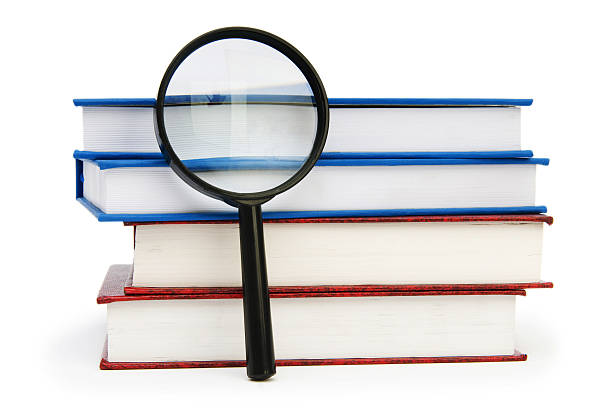 istock Magnifying glass over the stack of books 104266274
