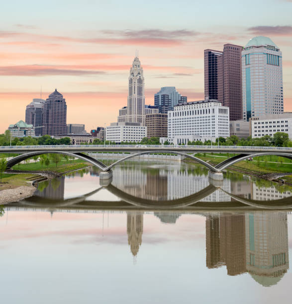 istock Warm colored morning clouds over Columbus Ohio with river reflection 1042673960