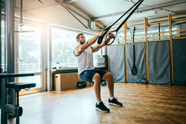 Young man workout with TRX Suspension Young man workout suspension training stock pictures, royalty-free photos & images