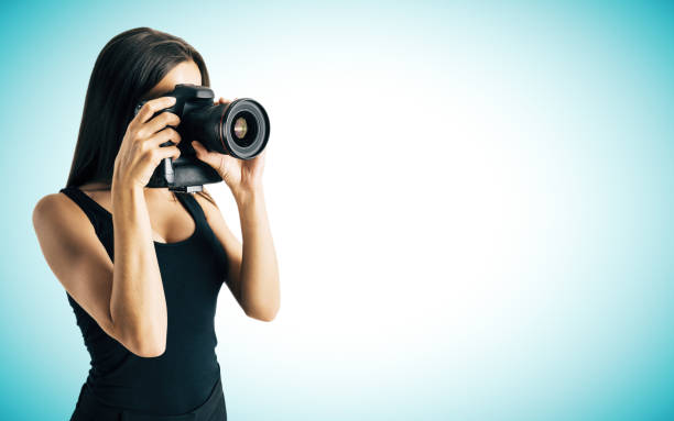 istock Woman taking photo on blue background 1042688168