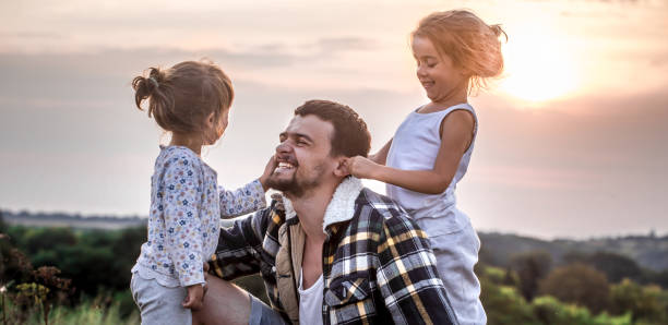 istock dad playing with two little cute daughters 1042695386