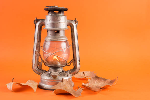 istock Gas lantern with burning light and fallen dry leaves 1042703388