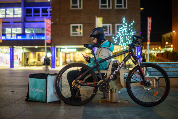 Coventry Town Centre DELIVEROO Currier is setting Navigation for serving food from Restaurant to Customer. Coventry, UK - JANUARY 29, 2018 : Coventry Town Centre DELIVEROO Currier is setting Navigation for serving food from Restaurant to Customer. coventry godiva stock pictures, royalty-free photos & images