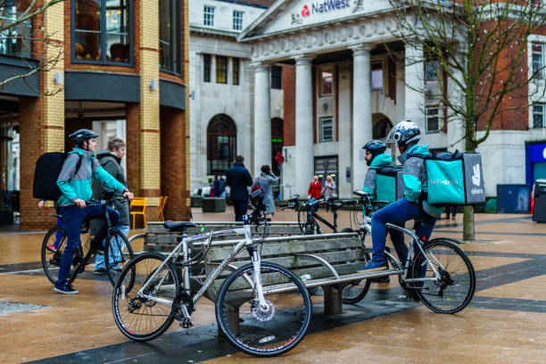 Coventry Town Centre DELIVEROO Currier is setting Navigation for serving food from Restaurant to Customer. Coventry, UK - JANUARY 28, 2018 : Coventry Town Centre DELIVEROO Currier is setting Navigation for serving food from Restaurant to Customer. coventry godiva stock pictures, royalty-free photos & images