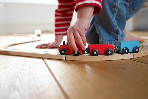 istock Child playing with toy wooden train 104271430