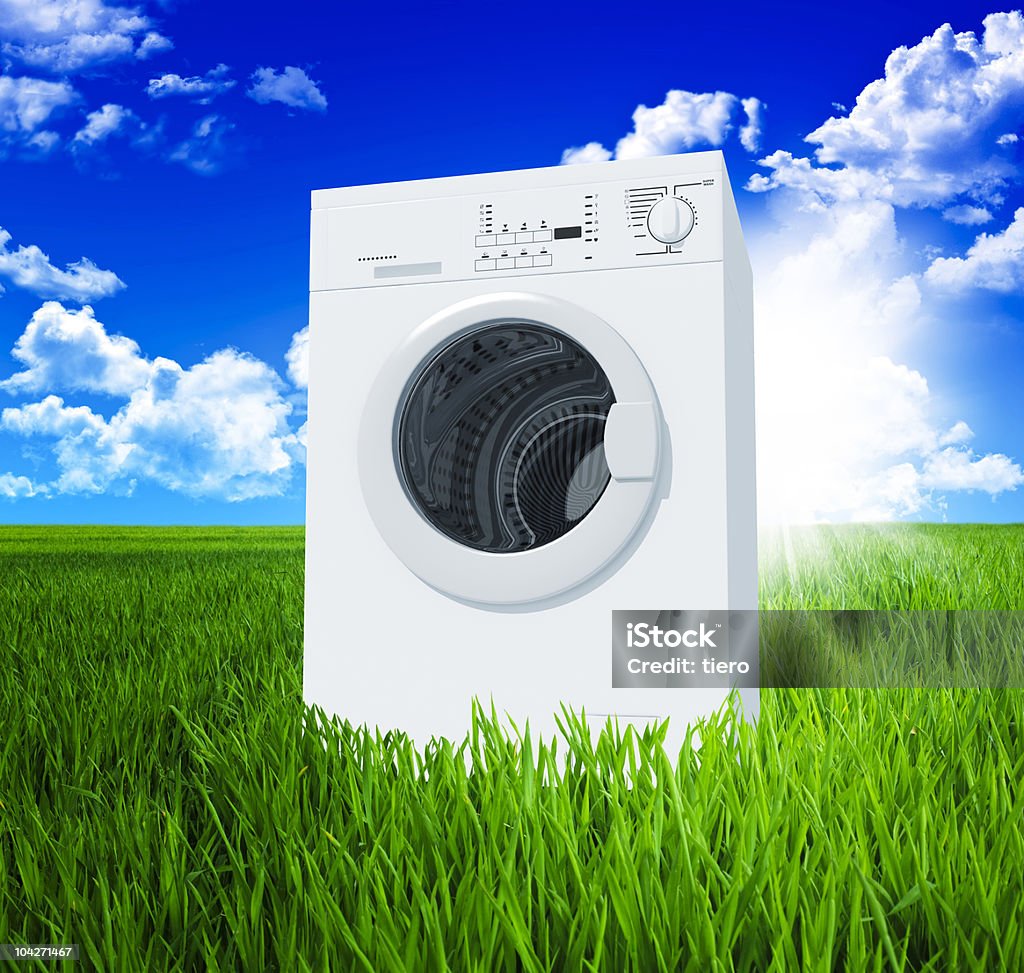 washing machine and green  field  Appliance Stock Photo