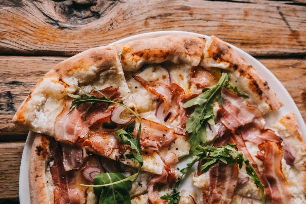 istock Overhead pizza carbonara on rustic wooden table 1042715624