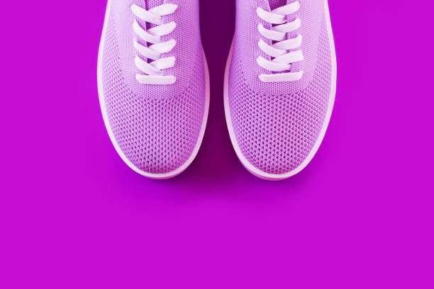 istock Violet sneakers with on a purple background. 1042715942