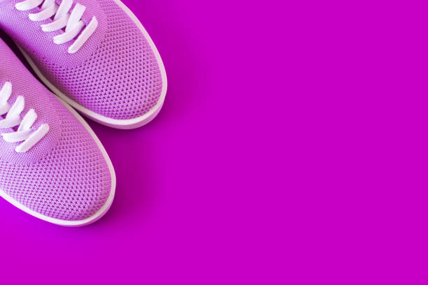 istock Violet sneakers with on a purple background. 1042715964