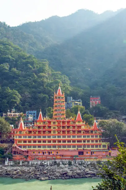 Photo of Spectacular view of the Lakshman Temple (Trayambakeshwar Temple)bathed by the sacred river Ganges. Uttarakhand, Rishikesh, India.