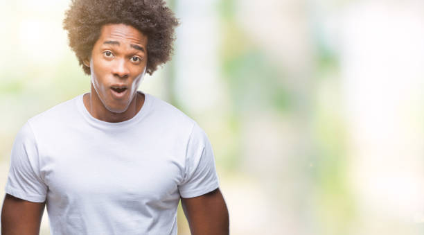 istock Afro american man over isolated background afraid and shocked with surprise expression, fear and excited face. 1042722930