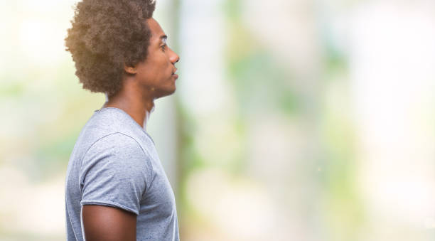 istock Afro american man over isolated background looking to side, relax profile pose with natural face with confident smile. 1042723352